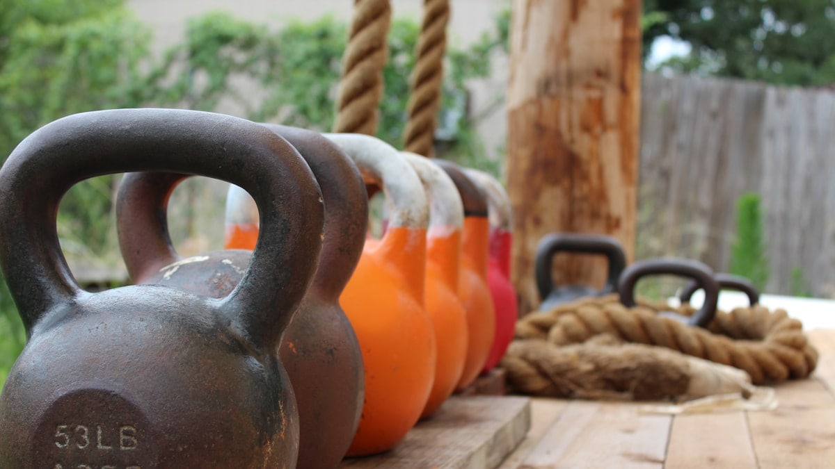 a row of kettles sitting on top of a wooden table
